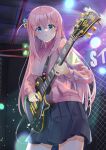  1girl bangs blue_eyes bocchi_the_rock! chain-link_fence cube_hair_ornament dusu_(htkj) electric_guitar fence gibson_les_paul gotou_hitori guitar hair_between_eyes hair_ornament highres holding holding_instrument indoors instrument jacket long_hair long_sleeves looking_at_viewer music one_side_up open_mouth pink_hair pink_jacket playing_instrument pleated_skirt skirt solo sweat track_jacket 