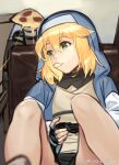  1boy akisa_yositake bangs blonde_hair bridget_(guilty_gear) chips_(food) closed_mouth commentary_request couch fingerless_gloves food gloves green_eyes guilty_gear guilty_gear_strive hair_between_eyes legs_up looking_to_the_side male_focus mouth_hold on_couch otoko_no_ko pizza pizza_slice playing_games playstation_controller potato_chips sitting solo twitter_username 