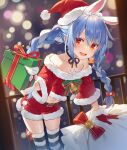  1girl :d animal_ears bangs bare_shoulders belt black_thighhighs blue_hair blurry bokeh box braid carrot_hair_ornament christmas commentary cowboy_shot depth_of_field food-themed_hair_ornament fur-trimmed_gloves fur-trimmed_shorts fur_trim gift gift_box gloves hair_between_eyes hair_ornament hat highres hikimayu holding holding_gift hololive incoming_gift leaning_forward looking_at_viewer midriff navel open_mouth rabbit_ears rabbit_girl red_eyes red_gloves red_shorts sack santa_costume santa_hat short_eyebrows short_shorts shorts smile solo standing striped striped_thighhighs thick_eyebrows thighhighs twin_braids usada_pekora virtual_youtuber white_thighhighs yuuki_hagure 