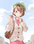  1girl alternate_eye_color ayaro_(genkiloobaii) backpack bag bob_cut brown_bag brown_hair buttons cable_knit cardigan cloud collared_dress commentary_request day dress eyelashes glint gloria_(pokemon) green_headwear grey_cardigan hat highres holding holding_poke_ball holding_strap hooded_cardigan looking_at_viewer outdoors pink_dress pink_eyes poke_ball poke_ball_(basic) pokemon pokemon_(game) pokemon_swsh short_hair sky solo tam_o&#039;_shanter 