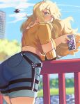  1girl absurdres ass bent_over blonde_hair blue_shorts blue_sky breasts can commentary crop_top day denim from_behind hentaly highres large_breasts long_hair looking_at_viewer looking_back mechanical_arms o-ring outdoors park purple_eyes railing rwby shorts single_mechanical_arm sky soda_can solo symbol-only_commentary wind wind_lift yang_xiao_long 