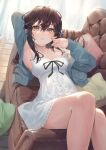  1girl absurdres arm_behind_head armpits blue_cardigan blush breasts brown_eyes brown_hair cardigan couch dress feet_out_of_frame hair_between_eyes hands_up highres kinoruru_toiro long_hair medium_breasts original parted_lips pillow reclining solo white_dress 