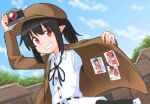 1girl black_hair black_skirt cabbie_hat camera collared_shirt flat_cap grin hakurei_reimu hat highres holding holding_camera jacket long_sleeves low_ponytail neck_ribbon no_wings official_alternate_costume outdoors photo_(object) pointy_ears red_eyes ribbon shameimaru_aya shameimaru_aya_(newsboy) shirt skirt smile solo suit_jacket touhou white_shirt yakousei_no_kame 