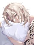  1boy albedo_(genshin_impact) blonde_hair ear_piercing earrings english_commentary genshin_impact green_eyes head_on_pillow highres holding holding_pillow jewelry looking_at_viewer lying male_focus messy_hair no_shirt on_stomach parted_hair piercing pillow short_hair shoulder_tattoo sidelocks signature simple_background solo tattoo twitter_username upper_body white_background yuun_ko 