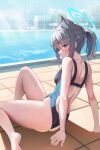  1girl absurdres animal_ear_fluff animal_ears ass blue_archive blue_eyes blush breasts competition_swimsuit cross_hair_ornament day from_side grey_hair hair_ornament halo highleg highleg_swimsuit highres looking_at_viewer looking_to_the_side one-piece_swimsuit outdoors ponytail poolside profile shiroko_(blue_archive) sitting small_breasts solo swimsuit thighs wet wolf_ears yuchae 