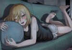  1girl bangs barefoot black_tank_top blonde_hair blue_eyes blush breasts cleavage commentary_request couch eyelashes feet feet_up full_body grey_shorts hair_between_eyes highres indoors legs lying medium_hair object_hug on_stomach one_eye_closed original pillow pillow_hug scar short_shorts shorts sleeveless soles solo swept_bangs tabao tank_top toes 
