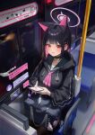  1girl absurdres animal_ears bag black_choker black_hair blue_archive blush bus_interior cellphone choker collarbone colored_inner_hair commentary_request dong_ji halo highres holding holding_phone kazusa_(blue_archive) long_sleeves looking_at_viewer multicolored_hair phone pink_hair red_eyes school_bag school_uniform sitting solo 