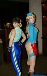  2girls ass bangs black_hair blonde_hair cammy_white cammy_white_(cosplay) capcom chun-li chun-li_(cosplay) cosplay hands_on_hips huge_ass ikuy indoors leotard long_hair looking_at_viewer looking_back multiple_girls no_bra photo real street_fighter thong_leotard twin_braids 