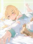  1girl bangs barefoot blonde_hair blue_eyes blush closed_mouth hair_between_eyes hair_ornament hairclip hana_mori hand_on_own_arm highres hololive kazama_iroha long_hair looking_at_viewer loose_clothes lying on_bed on_stomach outstretched_arm pokobee the_pose virtual_youtuber 
