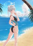  1girl absurdres animal_ear_fluff animal_ears ass bangs beach black_one-piece_swimsuit blue_archive blue_eyes blue_sky breasts cloud competition_swimsuit covered_navel cross_hair_ornament day extra_ears feet_out_of_frame from_behind grey_hair hair_ornament halo highleg highleg_swimsuit highres horizon kcc_(tanimahimeyuri) looking_back looking_to_the_side low_ponytail medium_breasts medium_hair mismatched_pupils multicolored_clothes multicolored_swimsuit ocean one-piece_swimsuit outdoors palm_tree shiroko_(blue_archive) shiroko_(swimsuit)_(blue_archive) sky solo swimsuit tree 