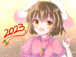  1girl 2023 :d animal_ears bangs blush brown_eyes brown_hair carrot_necklace chinese_zodiac commentary_request floppy_ears frilled_sleeves frills inaba_tewi jewelry looking_at_viewer necklace open_mouth pink_shirt pointing pointing_up rabbit_ears rabbit_girl shirt short_hair smile solo touhou upper_body year_of_the_rabbit yukishiro_yayoi 