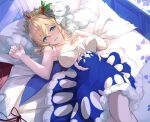  1girl bare_arms bare_shoulders bed blanket blonde_hair blue_dress blue_eyes blush breasts breasts_apart dress europa_(granblue_fantasy) feet_out_of_frame fur-trimmed_dress fur_trim granblue_fantasy hair_ornament hand_on_own_chest highres indoors looking_at_viewer lying medium_breasts nos on_back open_mouth pillow pinecone short_hair solo strapless strapless_dress tiara 
