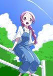  1girl :d alternate_hairstyle blue_overalls blush braid braided_ponytail cloud commentary_request eyelashes fence hanasaki_tsubomi happy heartcatch_precure! highres long_hair looking_at_viewer low_ponytail matatabi_(karukan222) open_mouth overalls pink_eyes pink_hair ponytail precure shirt sitting sitting_on_fence sky smile solo white_shirt 