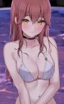  1girl bare_arms bare_shoulders bikini black_choker blurry breasts choker cleavage closed_mouth collarbone depth_of_field halterneck highres kaetzchen liliya_(kaetzchen) long_hair looking_at_viewer medium_breasts mole mole_on_breast navel original pool red_hair smile solo stomach string_bikini swimsuit upper_body wet white_bikini yellow_eyes 