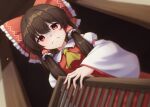  1girl ascot bare_shoulders blurry blurry_foreground bow breasts brown_hair commentary_request depth_of_field detached_sleeves disappointed dutch_angle frilled_bow frilled_shirt_collar frills from_below frown furrowed_brow hair_between_eyes hair_bow hair_tubes hakurei_reimu highres long_hair long_sleeves looking_at_viewer medium_breasts pov red_bow red_eyes red_skirt red_vest shaded_face skirt skirt_set solo touhou vest wide_sleeves yellow_ascot yosshy 
