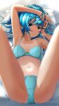  1girl aigami_kaon blue_bra blue_eyes blue_hair blue_panties blurry bra breasts commentary_request depth_of_field garter-velvet highres looking_at_viewer lying medium_breasts medium_hair one-piece_tan original panties pillow sitting solo tan tanlines underwear underwear_only 