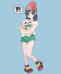  1boy bare_legs beanie black_footwear black_hair blush closed_mouth commentary cosplay elio_(pokemon) floral_print full_body green_shorts grey_eyes hat highres holding holding_pokemon knees long_hair male_focus pokemon pokemon_(creature) pokemon_(game) pokemon_sm red_headwear rowlet sana_(37pisana) selene_(pokemon) selene_(pokemon)_(cosplay) shirt shoes short_sleeves shorts smile spoken_character symbol-only_commentary t-shirt tied_shirt yellow_shirt 
