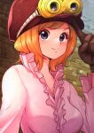  1girl aosora2823 blush breasts brick_wall brown_gloves cabbie_hat gloves goggles goggles_on_head hat highres koala_(one_piece) long_sleeves medium_breasts one_piece orange_hair pink_shirt shirt short_hair smile solo upper_body 