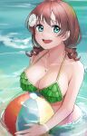  1girl ball beachball bikini blue_eyes blush breasts brown_hair collarbone commentary day drill_hair emma_verde flower flower_bracelet freckles frilled_bikini frills green_bikini hair_between_eyes hair_flower hair_ornament highres holding holding_ball jewelry large_breasts looking_at_viewer love_live! love_live!_nijigasaki_high_school_idol_club medium_hair necklace ocean on_water open_mouth outdoors partially_submerged shinyoujurin smile solo sunlight swimsuit symbol-only_commentary teeth upper_body upper_teeth_only 