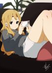  1girl absurdres blonde_hair blue_eyes casual cellphone closed_mouth commentary_request couch grey_shirt highres holding holding_phone indoors k-on! kicchi_(tmgk) kotobuki_tsumugi long_hair long_sleeves lying on_back phone pillow shirt shorts sidelocks signature smartphone solo thick_eyebrows white_shorts wireless_earphones 