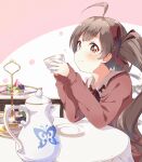  1girl ahoge blush bow brown_eyes brown_hair cake chair closed_mouth cup elbows_on_table food hair_ribbon hakozaki_serika holding holding_cup idolmaster idolmaster_million_live! idolmaster_million_live!_theater_days long_hair long_sleeves looking_at_viewer macaron pink_background plate red_ribbon ribbon sitting smile solo table teapot tiered_tray toma_(shinozaki) twintails two-tone_background very_long_hair white_background 
