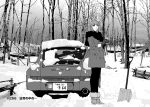  1girl bare_tree boots car forest fur-trimmed_footwear gloves greyscale high_heel_boots high_heels jacket kanojo_no_carrera kikuchi_michitaka long_hair looking_at_viewer mole mole_under_mouth monochrome motor_vehicle nature official_art pantyhose porsche porsche_911 porsche_964 scarf shovel smile snow sports_car todoroki_reina tree 