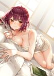  1girl alt_(ctrldel) atelier_(series) atelier_sophie bed_sheet blush book breasts brown_eyes cleavage closed_mouth collarbone commentary_request fingernails highres large_breasts looking_at_viewer lying off_shoulder on_stomach pillow red_hair short_hair smile solo sophie_neuenmuller 