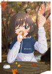  absurdres akiyama_yukari autumn blush border brown_eyes brown_hair coffee colombia cup drinking girls_und_panzer highres holding holding_cup holding_leaf jacket leaf maikaooba maple_leaf one_eye_closed photo_background short_hair table track_jacket white_border wooden_table 