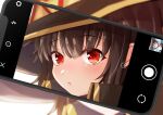  1girl bangs black_cape black_headwear blurry blurry_background blush brown_hair camera_phone cape cellphone cellphone_picture close-up commentary from_side hair_between_eyes hat highres kono_subarashii_sekai_ni_shukufuku_wo! looking_at_viewer looking_to_the_side megumin parted_lips phone portrait pov red_eyes ruriho short_hair short_hair_with_long_locks sidelocks smartphone solo taking_picture viewfinder witch_hat 