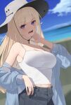  1girl beach black_pants blonde_hair blue_jacket blurry blurry_background blush breasts camisole cleavage collarbone day fingernails grey_headwear hat highres jacket kanpa_(campagne_9) large_breasts long_hair looking_at_viewer ocean open_clothes open_jacket open_mouth original outdoors pants purple_eyes solo white_camisole 