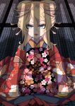  1girl blonde_hair blue_eyes floral_print_kimono hair_ornament hal_(goshujinomocha) highres indoors japanese_clothes kimono lipstick long_sleeves looking_at_viewer makeup oiran red_kimono red_lips seiza shadow shirt sitting solo tanya_degurechaff white_shirt wooden_floor youjo_senki 