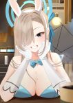  1girl :d arm_support asuna_(blue_archive) asuna_(bunny)_(blue_archive) blue_archive blue_bow blue_bowtie blue_eyes blue_leotard blurry bow bowtie breasts brown_hair cafe cleavage coffee collarbone commentary_request cup depth_of_field detached_collar elbow_gloves gloves hair_bow hair_over_one_eye hair_ribbon halo head_rest highres indoors kokolokokomika large_breasts leaning_forward leotard long_bangs long_hair looking_at_viewer mole mole_on_breast official_alternate_costume playboy_bunny ribbon sidelocks sleeveless smile solo strapless strapless_leotard table teacup white_gloves 