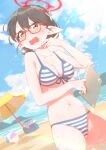  1girl ayane_(blue_archive) ayane_(swimsuit)_(blue_archive) ball beach beach_umbrella beachball bikini black_hair blue_archive blue_bikini blue_sky breasts cloud cloudy_sky collarbone commentary_request day flower front-tie_bikini_top front-tie_top glasses hair_flower hair_ornament halo hand_up holding holding_notebook holding_pen lens_flare medium_breasts mountainous_horizon notebook ocean official_alternate_costume open_mouth outdoors pen pointy_ears red-framed_eyewear red_halo short_hair sky solo standing striped striped_bikini sunlight sweat swimsuit tisca umbrella yellow_eyes 
