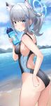  1girl absurdres animal_ear_fluff animal_ears ass beach black_one-piece_swimsuit blue_archive blue_eyes blue_sky bottle breasts cloud competition_swimsuit cross_hair_ornament day extra_ears grey_hair hair_ornament halo highres horizon looking_at_viewer looking_back low_ponytail medium_breasts medium_hair mismatched_pupils mountainous_horizon multicolored_clothes multicolored_swimsuit ocean official_alternate_costume one-piece_swimsuit outdoors saabyboi shiroko_(blue_archive) shiroko_(swimsuit)_(blue_archive) sky swimsuit wolf_ears 