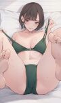  1girl absurdres ass ass_focus bare_legs barefoot bed_sheet bikini blush breasts brown_hair collarbone green_bikini highres koh_(minagi_kou) large_breasts legs_up looking_at_viewer lying mole mole_under_eye navel on_back original short_hair smile soles solo stomach sweat swimsuit toes 