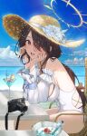  1girl absurdres beach black_hair blue_archive blue_sky blush breasts camera chair cloud cup day detached_sleeves drinking_straw flower hair_between_eyes halo hat hat_flower highres hinata_(blue_archive) kuren_kren large_breasts leaning_forward long_hair looking_at_viewer ocean one-piece_swimsuit open_mouth outdoors red_eyes sitting sky swimsuit white_flower white_one-piece_swimsuit 