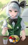  1girl absurdres black_bow black_bowtie black_hairband black_ribbon bow bow_hairband bowtie buttons commentary cup erisauria food fruit green_eyes green_vest hair_ribbon hairband highres holding holding_spoon ice_cream konpaku_youmu looking_at_viewer lower_teeth_only open_mouth puffy_short_sleeves puffy_sleeves ribbon shirt short_hair short_sleeves sleeve_cuffs solo spoon teeth tongue touhou upper_body vest white_hair white_shirt yunomi 