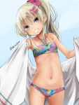  1girl akino_shuu bikini blonde_hair blush bow collarbone cowboy_shot grecale_(kancolle) green_eyes grin hair_between_eyes hair_bow jewelry kantai_collection long_hair looking_at_viewer navel necklace official_alternate_costume pink_bow smile solo swimsuit twitter_username 