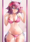  1girl absurdres animal_ears bikini blue_eyes blush breasts cellphone cleavage closed_mouth commentary_request flower hair_between_eyes hair_flower hair_ornament highres horse_ears horse_girl horse_tail medium_breasts medium_hair navel oryou_gunsou phone pink_hair sakura_chiyono_o_(umamusume) selfie smile solo swimsuit tail tan tanlines umamusume 