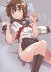  1girl black_sailor_collar black_skirt black_socks brown_eyes brown_hair clothes_in_front clothes_removed commentary_request feet_out_of_frame folded_ponytail haida_katsuretsu highres inazuma_(kancolle) kantai_collection kneehighs long_hair long_sleeves lying neckerchief nude pillow pleated_skirt red_neckerchief sailor_collar school_uniform serafuku skirt socks solo 