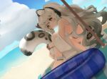  1girl animal_ear_fluff animal_ears arknights bare_shoulders beach braid breasts grey_eyes grey_hair hair_between_eyes holding leopard_ears leopard_girl leopard_tail long_hair looking_at_viewer panda_(azarashi_suki) pramanix_(arknights) side_braids snow_leopard solo spotted_tail swimsuit tail 