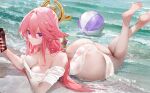  1girl alternate_costume animal_ears arm_under_breasts armpit_crease ass ball beach beachball bottle breasts cleavage collarbone earrings feet feet_up fox_ears genshin_impact hair_between_eyes holding holding_bottle jewelry long_hair looking_at_viewer lotion_bottle lying medium_breasts omone_hokoma_agm on_stomach phone pink_hair purple_eyes sidelocks solo water yae_miko 