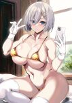  1girl alternate_costume areola_slip bikini blue_eyes breasts cellphone closed_mouth commentary_request covered_navel gloves gold_bikini grey_hair hair_between_eyes hair_ornament hairclip hamakaze_(kancolle) hands_up highleg highleg_bikini highres holding holding_phone indoors kantai_collection kyogoku_shin large_breasts looking_at_phone micro_bikini navel phone selfie short_hair sitting solo string_bikini swimsuit thighhighs thighs v variant_set white_gloves white_thighhighs 