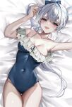  1girl arm_up armpits bare_arms bare_shoulders bed_sheet black_one-piece_swimsuit blue_archive blue_bow blue_halo blush bow breasts cleavage collarbone covered_navel cowboy_shot fang frilled_one-piece_swimsuit frills grey_hair groin hair_between_eyes hair_bow halo highres indoors long_hair looking_at_viewer lying medium_breasts miyako_(blue_archive) miyako_(swimsuit)_(blue_archive) off-shoulder_one-piece_swimsuit off_shoulder official_alternate_costume on_back on_bed one-piece_swimsuit open_mouth ponytail purple_eyes sidelocks skin_fang solo swimsuit thighs upper_body ya_ta 