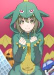  1girl :i absurdres animal_costume blush clenched_hands dragon_costume dragon_wings green_eyes green_hair highres hood hood_up idolmaster idolmaster_shiny_colors looking_at_viewer nanakusa_nichika official_alternate_costume pumpkin shignonpencil solo v-shaped_eyebrows wings 