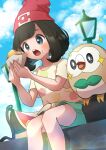  1girl :o absurdres beanie black_hair blush cloud commentary day eyelashes food food_on_face green_shorts grey_eyes hat highres holding malasada medium_hair open_mouth outdoors pokemon pokemon_(creature) pokemon_sm red_headwear refisa rowlet selene_(pokemon) shirt short_sleeves shorts sitting sky sparkle t-shirt teeth tongue upper_teeth_only yellow_shirt 