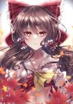  1girl ascot blurry blurry_foreground bow breasts brown_hair collarbone commentary frilled_bow frilled_hair_tubes frills hair_bow hair_tubes hakurei_reimu highres leaf long_hair looking_at_viewer maple_leaf mashiropuni midriff parted_lips print_bow red_bow red_eyes red_ribbon ribbon ribbon-trimmed_sleeves ribbon_trim signature small_breasts solo stomach touhou upper_body yellow_ascot 