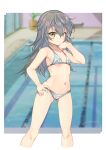  1girl alice_gear_aegis bikini blurry blurry_background brown_eyes feet_out_of_frame flat_chest gradient_hair hand_on_own_hip highres indoors long_hair looking_at_viewer multicolored_hair navel pool shinonome_chie silver_bikini smile solo standing swimsuit yashin_(yasinz) 