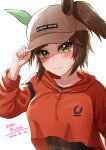  1girl adjusting_clothes adjusting_headwear animal_ears baseball_cap blush breasts brown_hair brown_headwear character_name closed_mouth commentary_request dated ear_covers ears_through_headwear green_eyes hat highres hood hood_down hoodie horse_ears horse_girl ines_fujin_(umamusume) large_breasts long_sleeves looking_at_viewer medium_hair official_alternate_costume orange_hoodie shinonome_(shinonome_rynn) shirt_overhang side_ponytail simple_background single_ear_cover smile solo umamusume upper_body white_background 