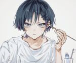  1boy applying_makeup ayu_kawa blue_hair dark_blue_hair genshin_impact grey_eyes hair_ornament hairclip highres holding holding_brush light_brown_background looking_at_viewer male_focus multicolored_hair purple_hair red_eyeliner scaramouche_(genshin_impact) shirt short_hair solo toothbrush toothpaste white_shirt 